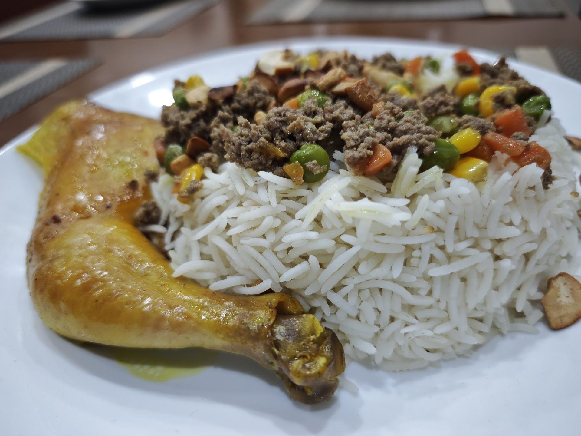 Palestinian ozi chicken served over spiced rice with minced meat and nuts